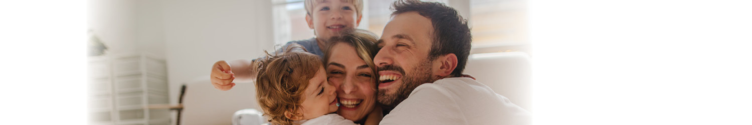 Family hugging in their Birmingham, AL home