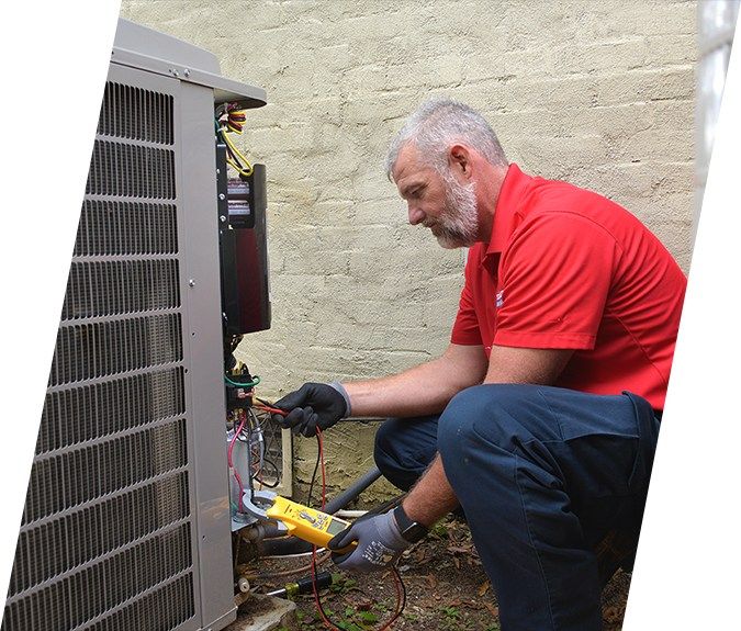 Standard HVAC tech servicing an air conditioner at a home in Birmingham, AL