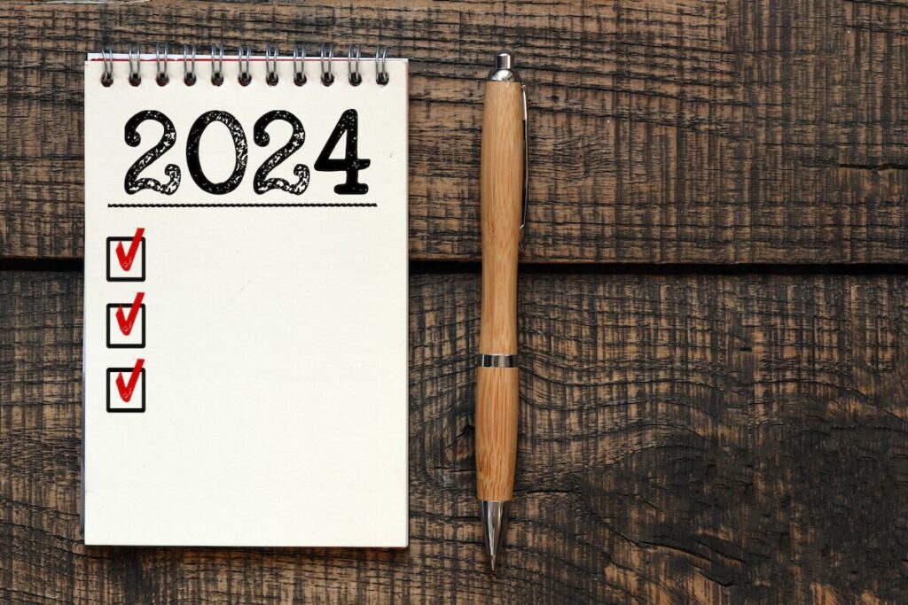 New year resolutions 2024 on desk. 2024 goals list with notebook. Resolutions, plan, goals, action, checklist, idea concept. New Year 2024 resolutions.