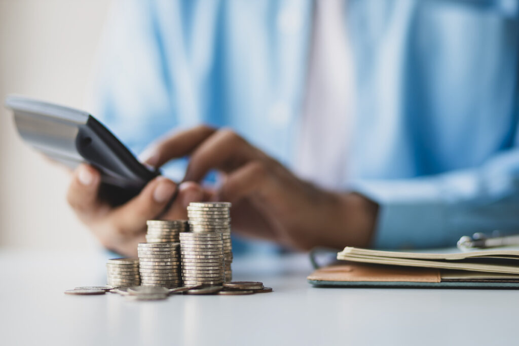 Financial planning and investment Businessman using calculator calculating income and expenditure for bookkeeping, saving money for the future and life after retirement