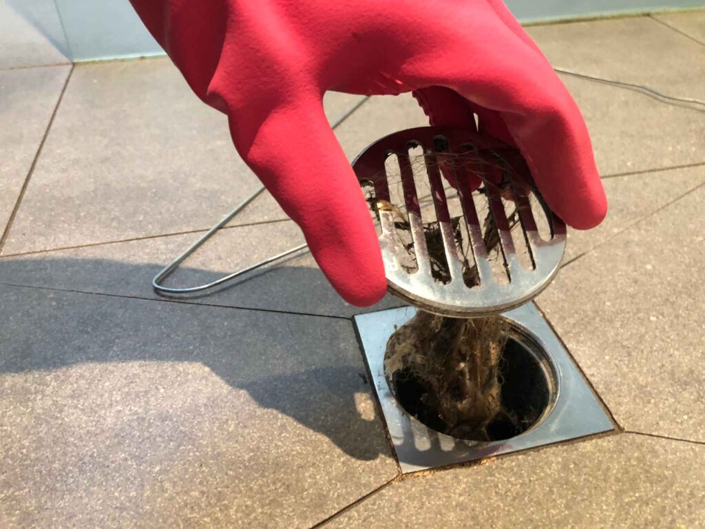Clearing the shower drain clogged with hair